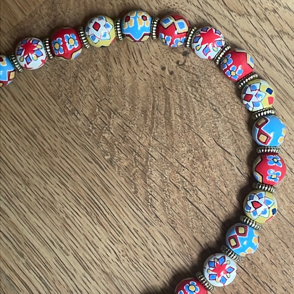 Angela Moore signature stretch necklace in Red, Yellow, Blue and White beads.